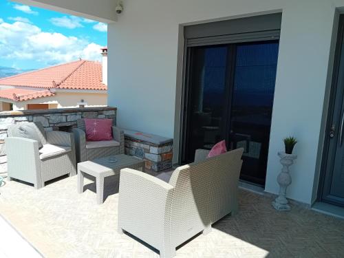 a patio with chairs and a couch and a table at Kappa house in Vélos