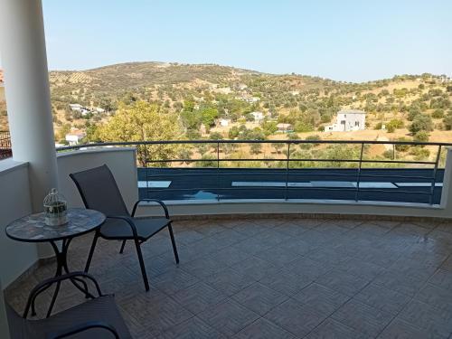 a balcony with a table and chairs and a view at Kappa house in Vélos