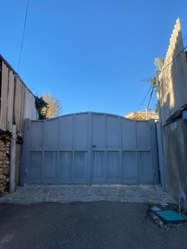 a gate in a fence in a driveway at Nekreseli in Sagarejo