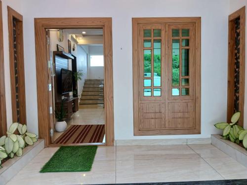 a hallway with a wooden door in a house at Sky Elanza in Munnar