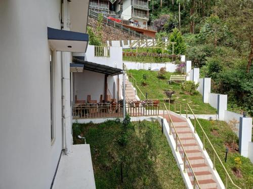 an external view of a building with tables and chairs at Sky Elanza in Munnar