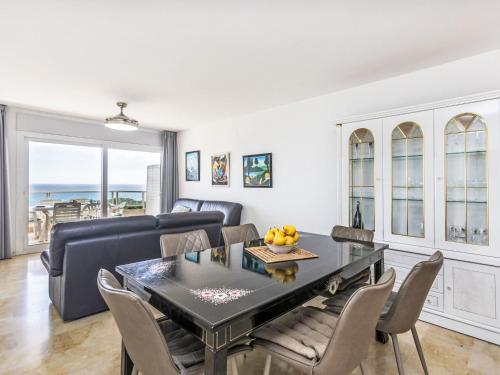 a living room with a table and chairs and a couch at Apartment Blanes Beach by Interhome in Blanes