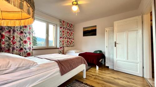 a bedroom with a bed and a window at zaKRZYWEk retro in Cisna