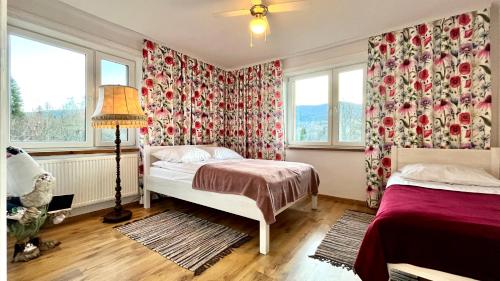 a bedroom with two beds and a window at zaKRZYWEk retro in Cisna
