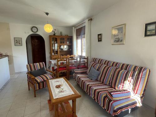 a living room with two couches and a table at Holiday Home Zaragoza by Interhome in Miami Platja