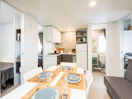 a kitchen and living room with a table and chairs at Holiday Home Happy Superior by Interhome in Rosapineta