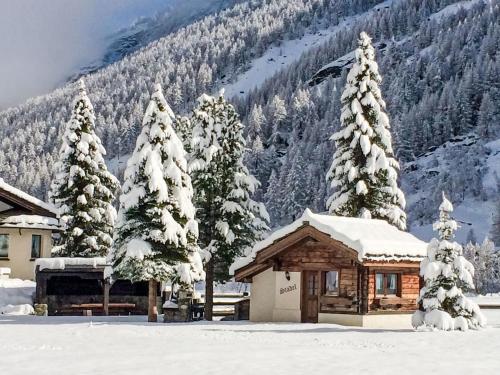 a cabin in the snow with snow covered trees at Chalet Häuschen Stadel by Interhome in Saas-Grund