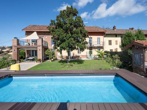 a swimming pool in the backyard of a house at Holiday Home Helix1912 by Interhome in San Damiano dʼAsti