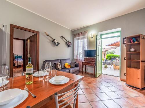 a dining room with a table and a living room at Holiday Home Zio-Nonno by Interhome in Portacomaro