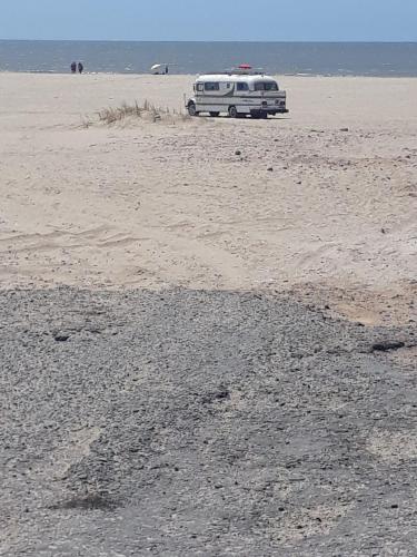 a white van parked on the beach at Playa & Campo - Experiencia Glamping en Mar de Ajó in Mar de Ajó