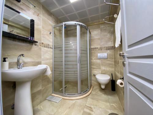 a bathroom with a shower and a sink and a toilet at Queen Bee Hotel in Selcuk