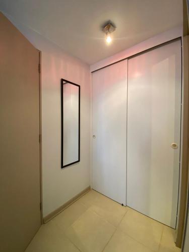 a room with a white door and a mirror at Acogedor y tranquilo departamento Mirasol in Algarrobo
