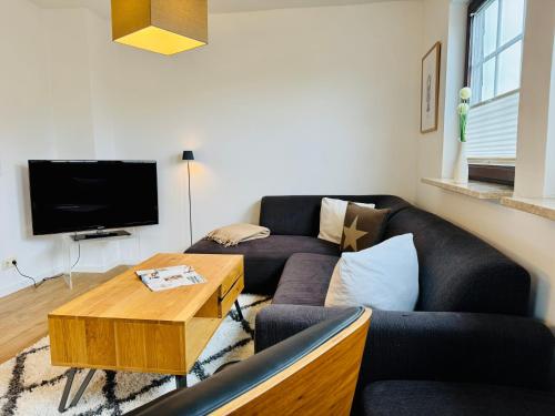 a living room with a couch and a coffee table at App Blaue Welle in Morsum