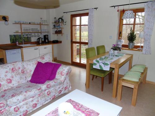 a living room with a couch and a table at Ferienhof Idyll am kleinen Fließ in Burg