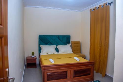 a small bedroom with a bed with a yellow mattress at New 237 de Luxe in Yaoundé