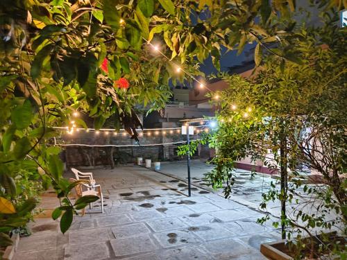 a garden with a string of lights in a building at Garden Villa, Hyderabad in Hyderabad