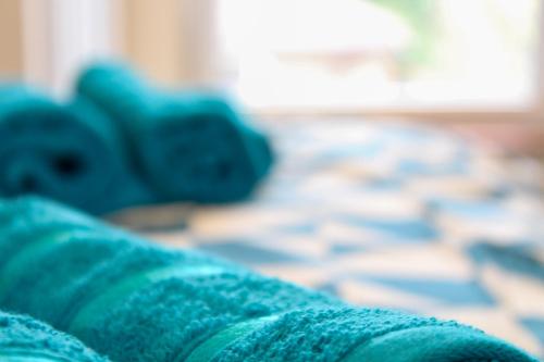 a close up of a blue blanket with a computer keyboard at Darwin road guest house 5 in Southampton