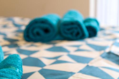 a group of blue roses laying on a bed at Darwin road guest house 5 in Southampton