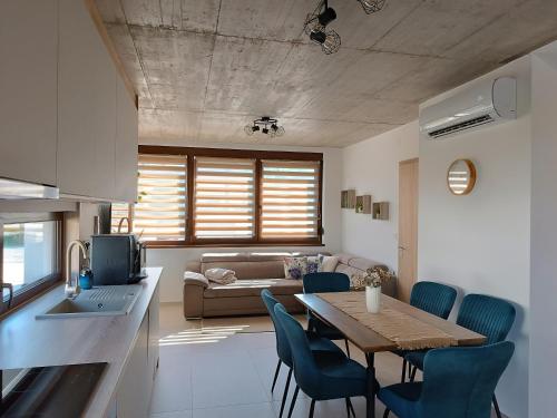 a kitchen and living room with a table and chairs at Nagy-Zátonyi Vendégház in Dunasziget