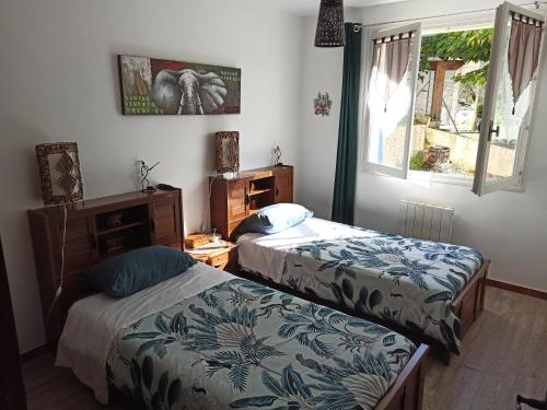 sypialnia z dwoma łóżkami i oknem w obiekcie Gîte la côte des bleuets de Retourtour w mieście Lamastre