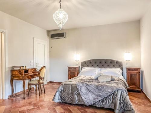a bedroom with a bed and a table and a desk at Villa Naldi Relais in San Carlo