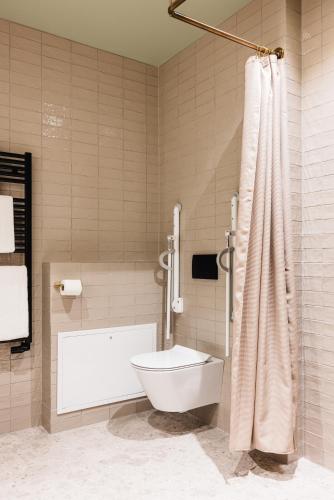 a bathroom with a toilet and a shower at Reykjavik Residence Apartment Hotel in Reykjavík