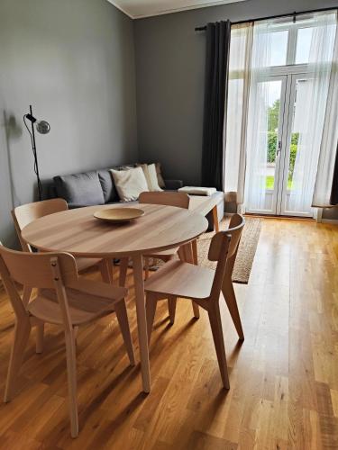 a table and chairs in a living room with a couch at Evje Park in Evje