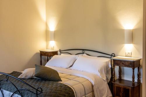 a bedroom with a bed with two lamps on it at Villa Naldi Relais in San Carlo