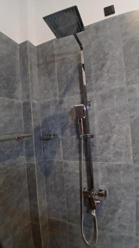a shower in a bathroom with a glass door at Coco Mount Residence - Hiriketiya in Dickwella
