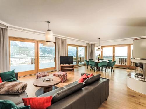a living room with a couch and a table at Apartment Panorama Dachstein by Interhome in Rohrmoos