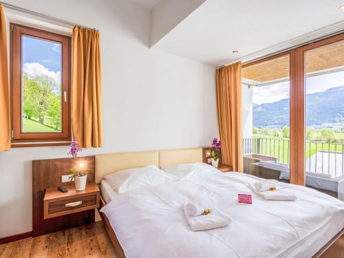 a bedroom with a large bed and a large window at Apartment Emma-8 by Interhome in Dürnberg
