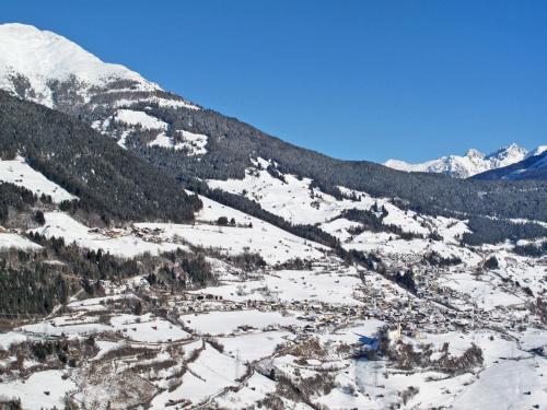 a view of a snowy mountain with a town at Apartment Alberts Huamat by Interhome in Urgen