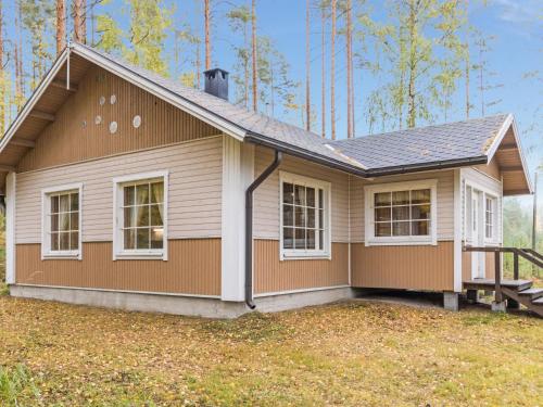 a small house with a gambrel roof at Holiday Home Papula by Interhome in Puumala