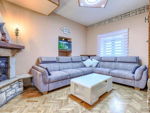 a living room with a couch and a fireplace at Holiday Home Bonita by Interhome in Šišan