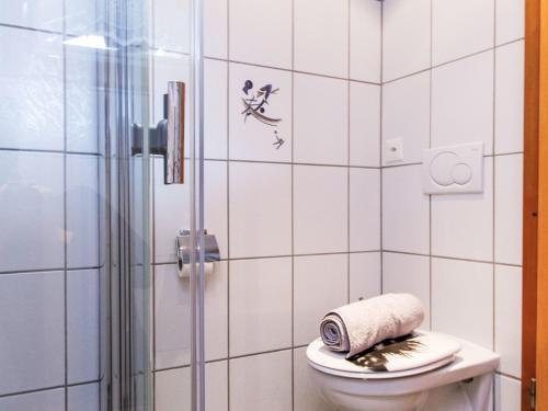 a bathroom with a toilet and a glass shower at Chalet Dominic by Interhome in Saclentse