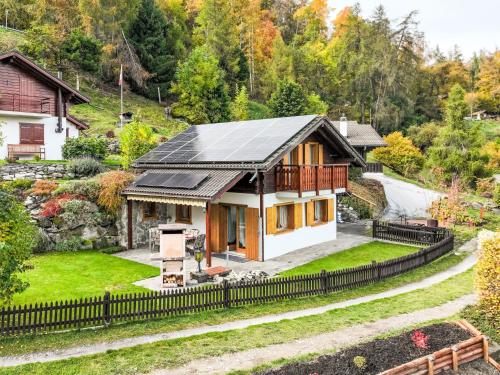 a house with solar panels on the roof at Chalet Dominic by Interhome in Saclentse