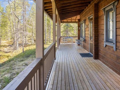 a porch of a wooden house with a bench on it at Holiday Home Kiehtäjän lahti by Interhome in Käylä