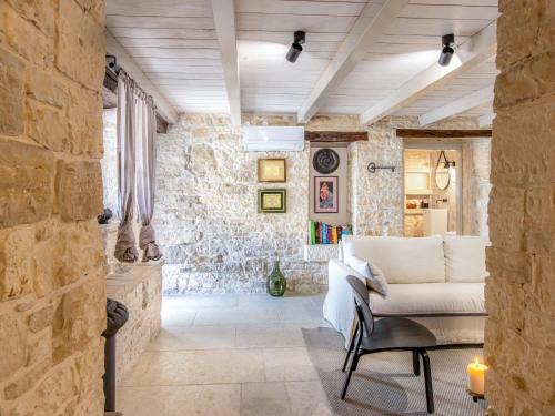a living room with a stone wall at Holiday Home Botra Maria Luxury by Interhome in Sveti Petar u Šumi