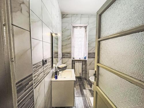 a small bathroom with a sink and a mirror at Holiday Home Francesca by Interhome in Quattordio