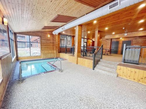 a swimming pool in the middle of a house at Ski in Ski out Cozy Studio Condo, Pool, Hot Tub, Views of Moose Mtn in Lutsen