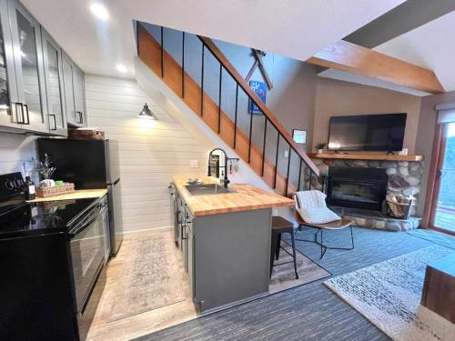 a kitchen with a sink and a staircase in a house at Ski in Ski out 1 Bed plus Loft BEST VIEWS IN LUTSEN in Lutsen
