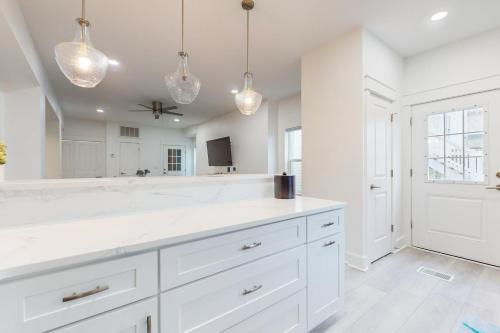 a kitchen with white cabinets and a large mirror at Bahia Beauty - 1st Floor in Navarre