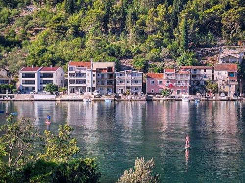 a group of houses on the water near a city at Apartment Jasmina-4 by Interhome in Blace