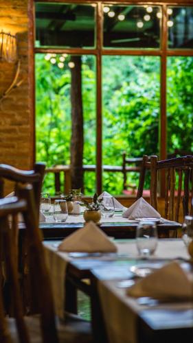 a table set up for a meal in a restaurant at La Aldea De La Selva Lodge in Puerto Iguazú