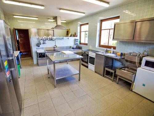 a large kitchen with stainless steel counters and appliances at Holiday Home Veselý Kopec by Interhome in Dřevíkov