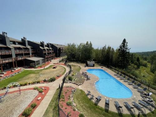 an aerial view of a resort with a swimming pool at Ski in Ski out Townhome, Indoor and outdoor pools, hot tub, fire pits, and more in Lutsen