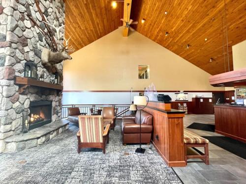 a lobby with a stone wall and a fireplace at Ski in Ski out Townhome, Indoor and outdoor pools, hot tub, fire pits, and more in Lutsen