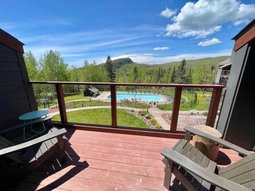 a deck with benches and a view of a pool at Lutsen Mtn Condo, Ski in Ski out, Pool, Hot Tub, Fitness in Lutsen