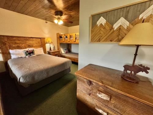 a bedroom with a bed and a table with a lamp at Condo at Lutsen Mtn, Ski in Ski out, Hike, Bike, Ski, Swim, etc in Lutsen