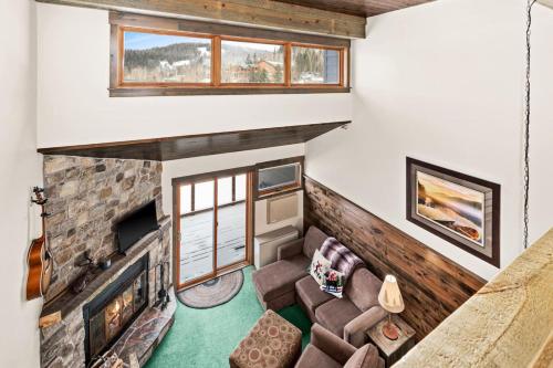 a living room with a couch and a fireplace at Condo at Lutsen Mtn, Ski in Ski out, Hike, Bike, Ski, Swim, etc in Lutsen